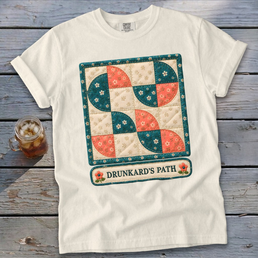 White t-shirt with "Drunkard's Path" quilt pattern and text.