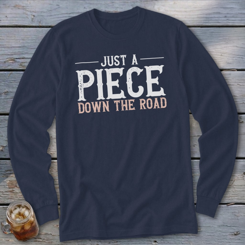 Navy long sleeve shirt with "Just A Piece Down The Road" text graphic.