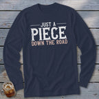 Navy long sleeve shirt with "Just A Piece Down The Road" text graphic.