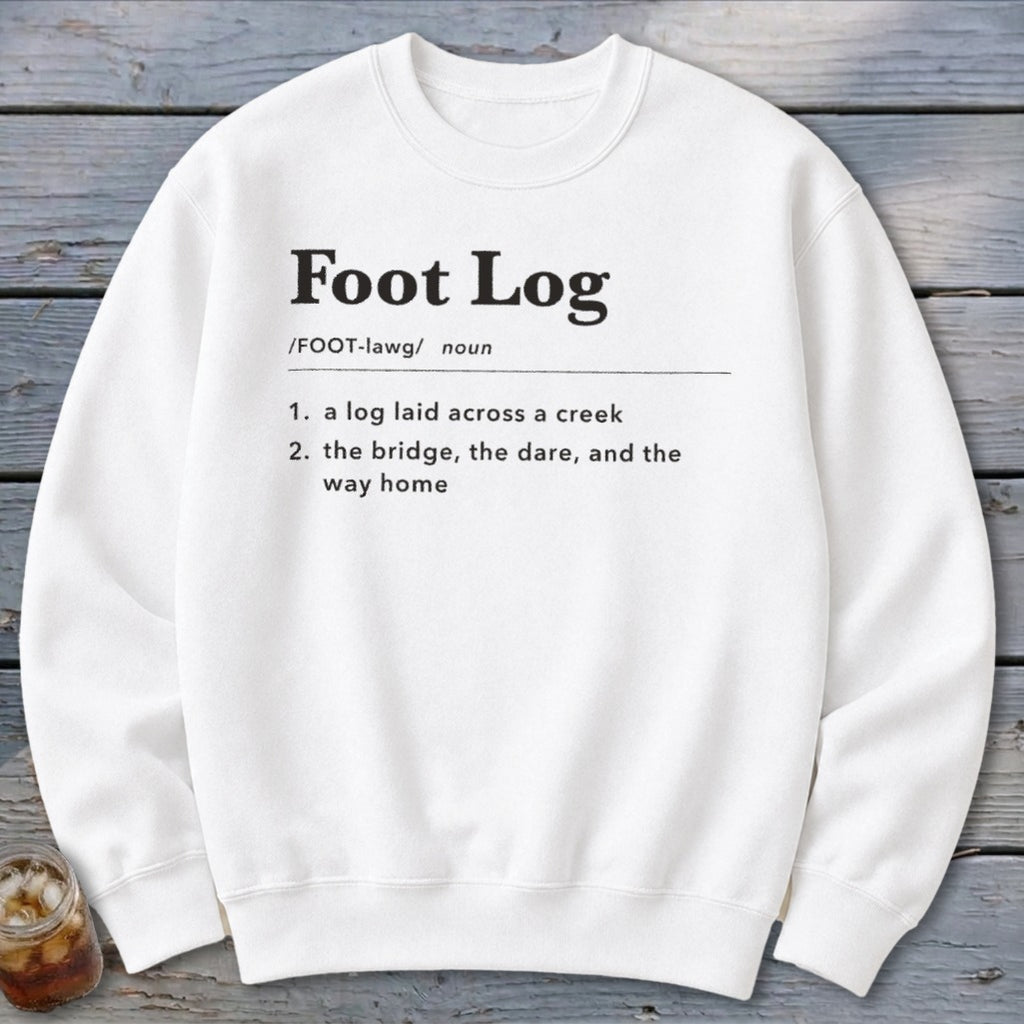 A white crewneck sweatshirt features black dictionary-style text defining the term Foot Log.