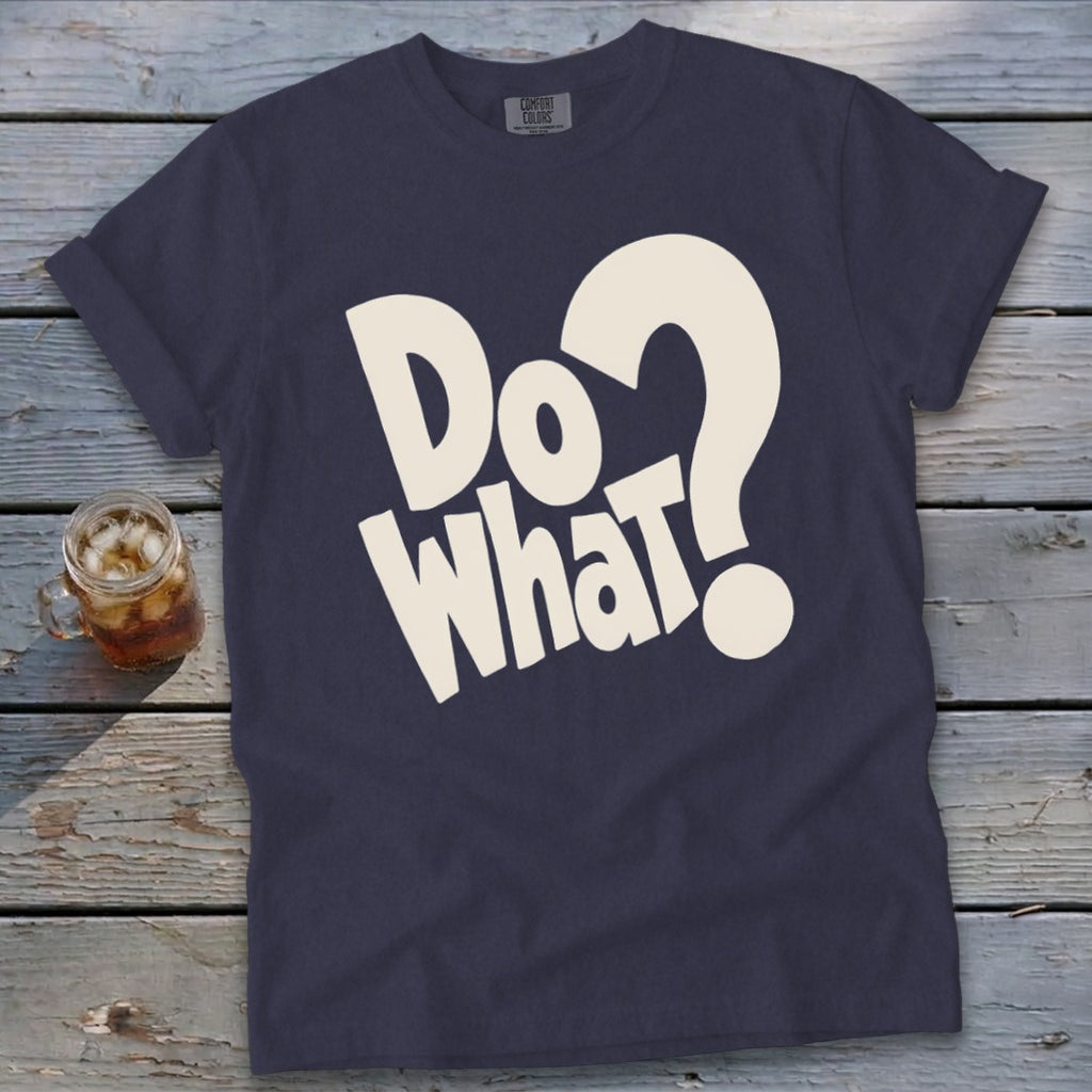 Dark blue crewneck t-shirt featuring bold, cream-colored text reading "Do What?" on a rustic wooden background.