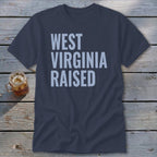 Navy t-shirt with "WEST VIRGINIA RAISED" text in light blue.