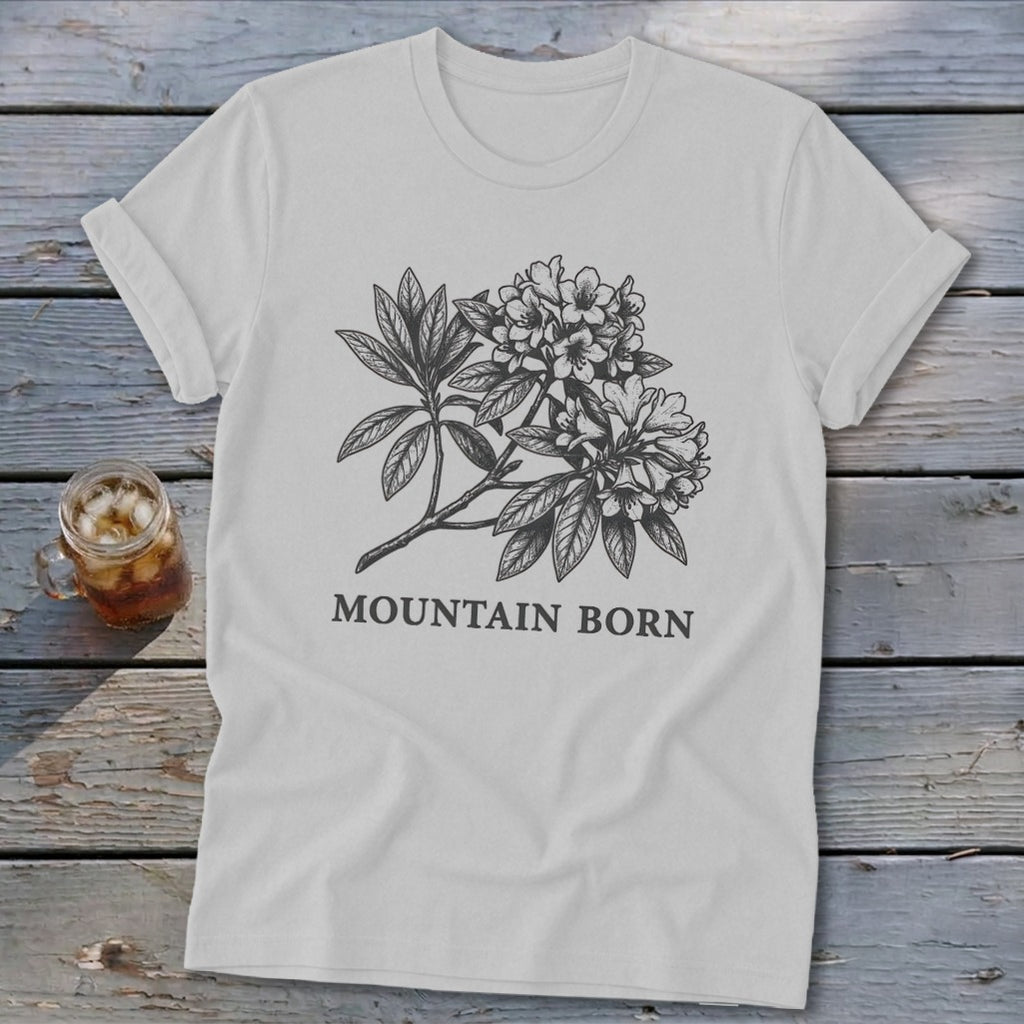 White t-shirt with a sketch of rhododendron flowers and the text "MOUNTAIN BORN".