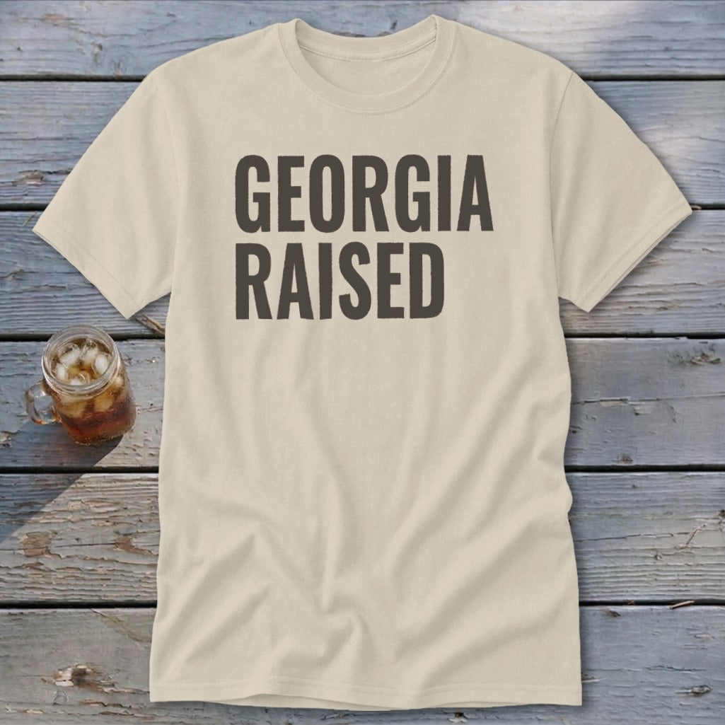 Cream t-shirt with bold gray text that reads "GEORGIA RAISED".