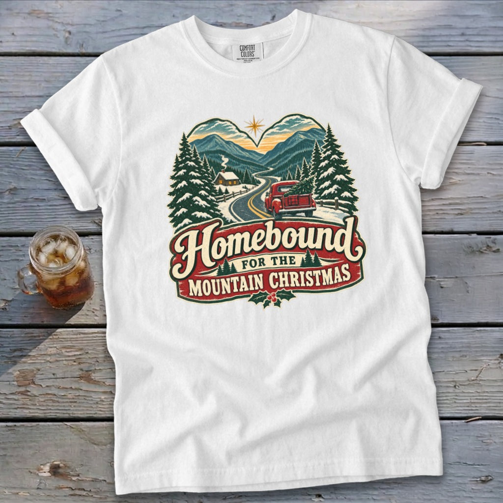 White t-shirt with "Homebound For The Mountain Christmas" graphic.