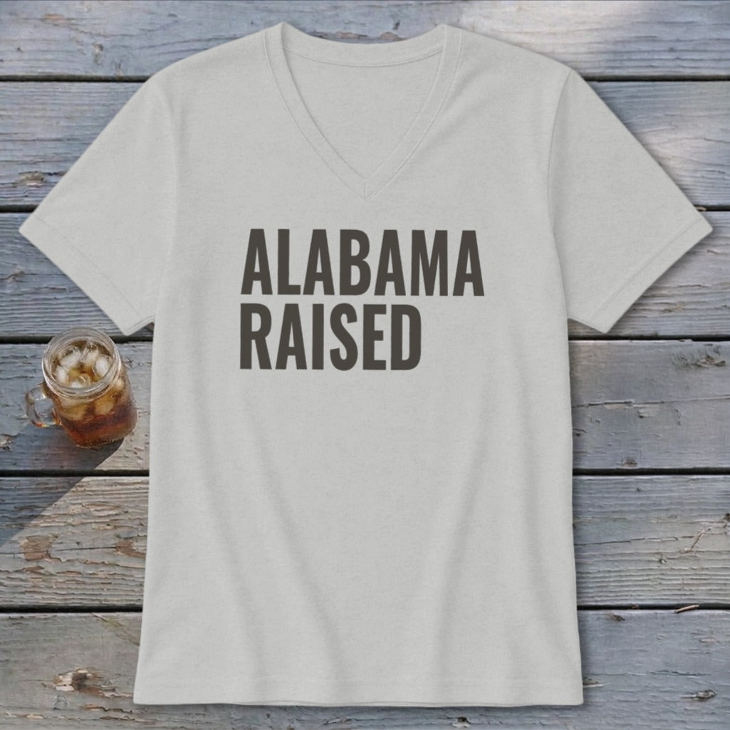 Light gray v-neck t-shirt with bold black text reading "ALABAMA RAISED".
