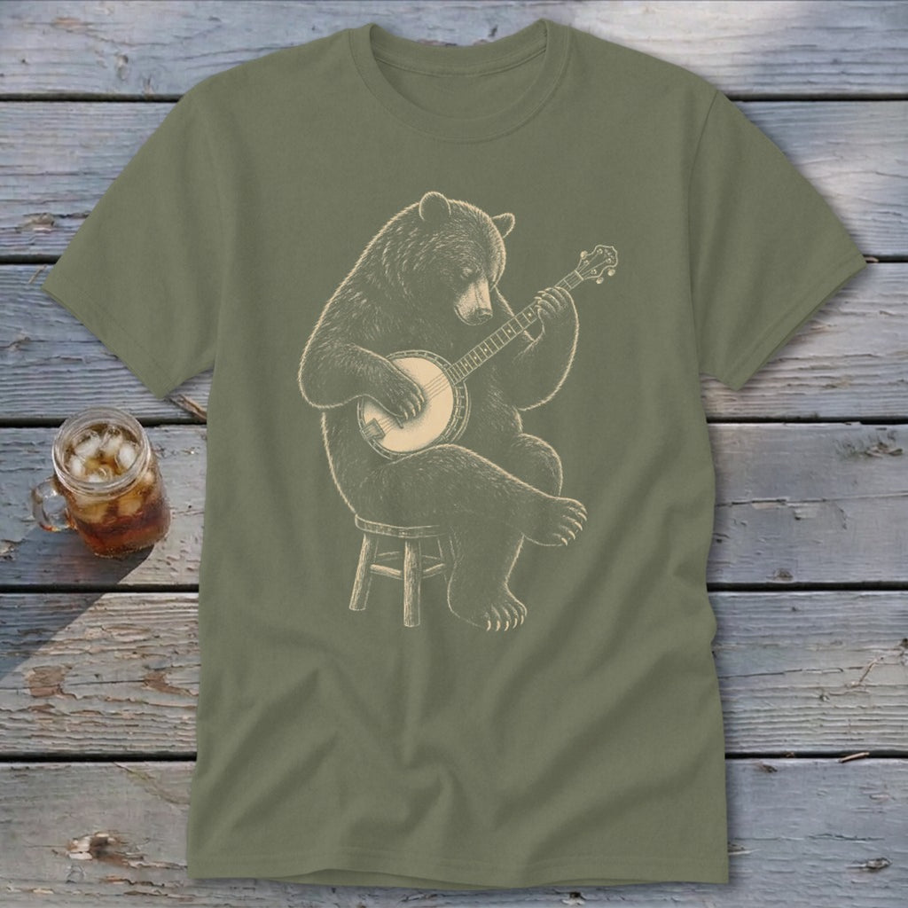 Bear sitting on stool playing banjo graphic on olive green t-shirt.