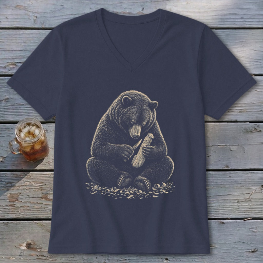 Dark blue v-neck t-shirt with a graphic of a bear carving wood with a knife.