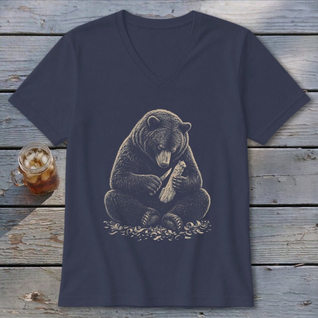 Dark blue v-neck t-shirt with a graphic of a bear carving wood with a knife.