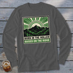 Charcoal grey long-sleeve t-shirt with a green and black graphic of mountains, trees, and the text Born in the Holler Raised on the Ridge.