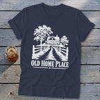 Navy t-shirt with white graphic of a farmhouse, trees, and fence, text reads "OLD HOME PLACE".