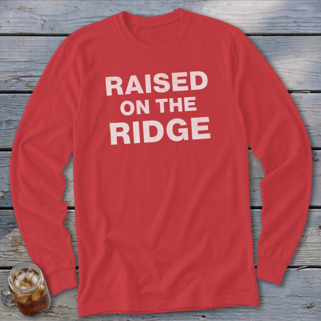 Red long-sleeve shirt with white text reading "RAISED ON THE RIDGE".