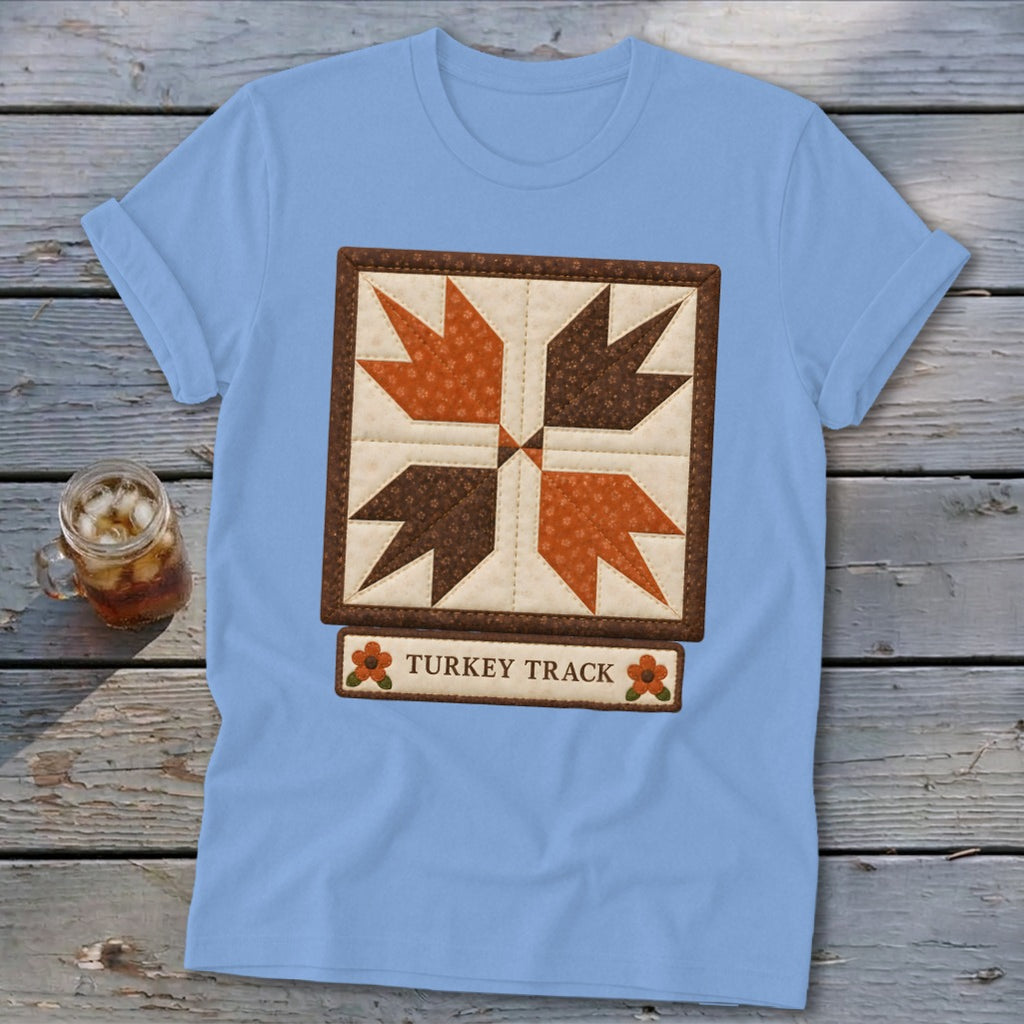 Light blue t-shirt with a square quilt block design featuring turkey tracks and the text "TURKEY TRACK".