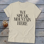 Cream t-shirt with dark text reading "WE SPEAK MOUNTAIN HERE"