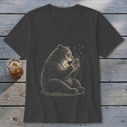 Bear sitting and holding a jar with fireflies, with a drink in a mason jar beside it.
