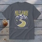Grey t-shirt with "MILES AWAY BUT MOUNTAIN BOUND" and mountain road graphic.