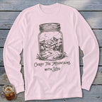 Light pink long-sleeve shirt with a graphic of a landscape inside a mason jar and text reading Carry The Mountains With You.