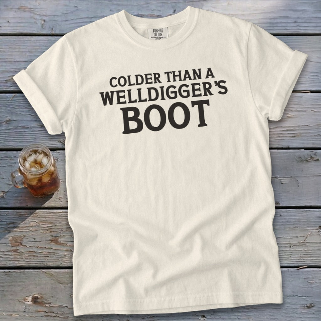 Cream t-shirt with black text that reads "Colder than a Welldigger's Boot".