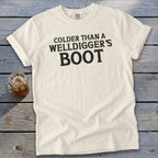 Cream t-shirt with black text that reads "Colder than a Welldigger's Boot".