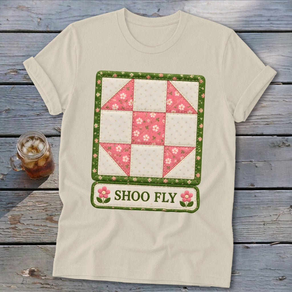 Cream t-shirt with a pink and white patchwork quilt block design and "SHOO FLY" text.