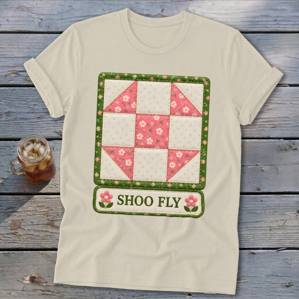 Cream t-shirt with a pink and white patchwork quilt block design and "SHOO FLY" text.