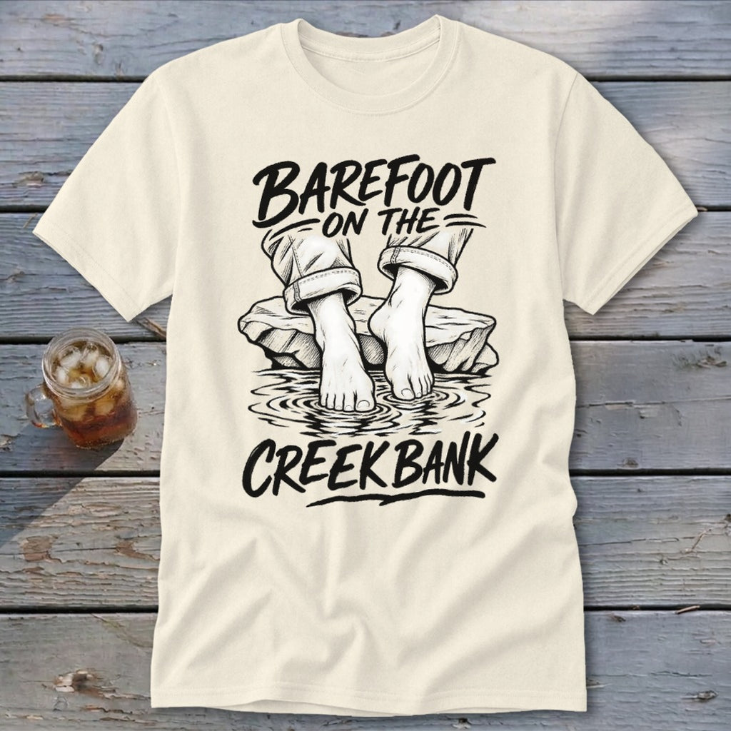 Cream t-shirt with "Barefoot on the Creek Bank" graphic of bare feet in water.