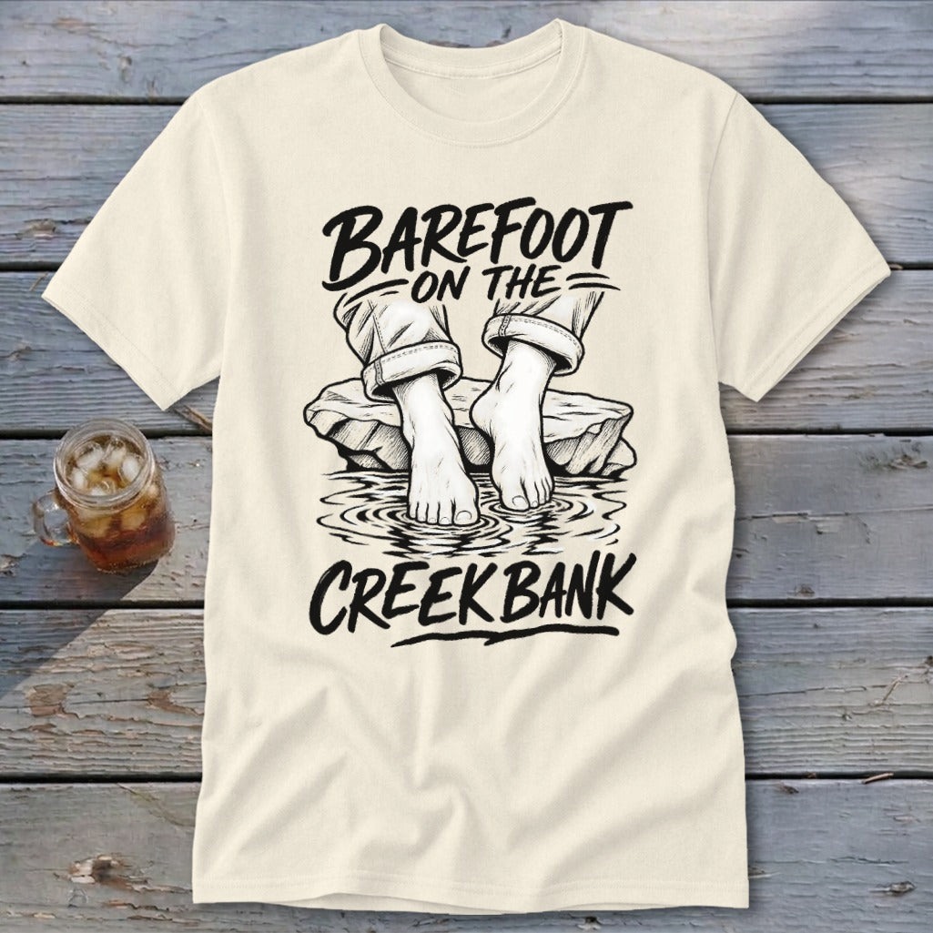 Cream t-shirt with "Barefoot on the Creek Bank" graphic of bare feet in water.