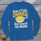 Royal blue long-sleeve t-shirt with a graphic of cornbread in a skillet and text reading Some of Y’all’s Cornbread Ain’t Done in the Middle.
