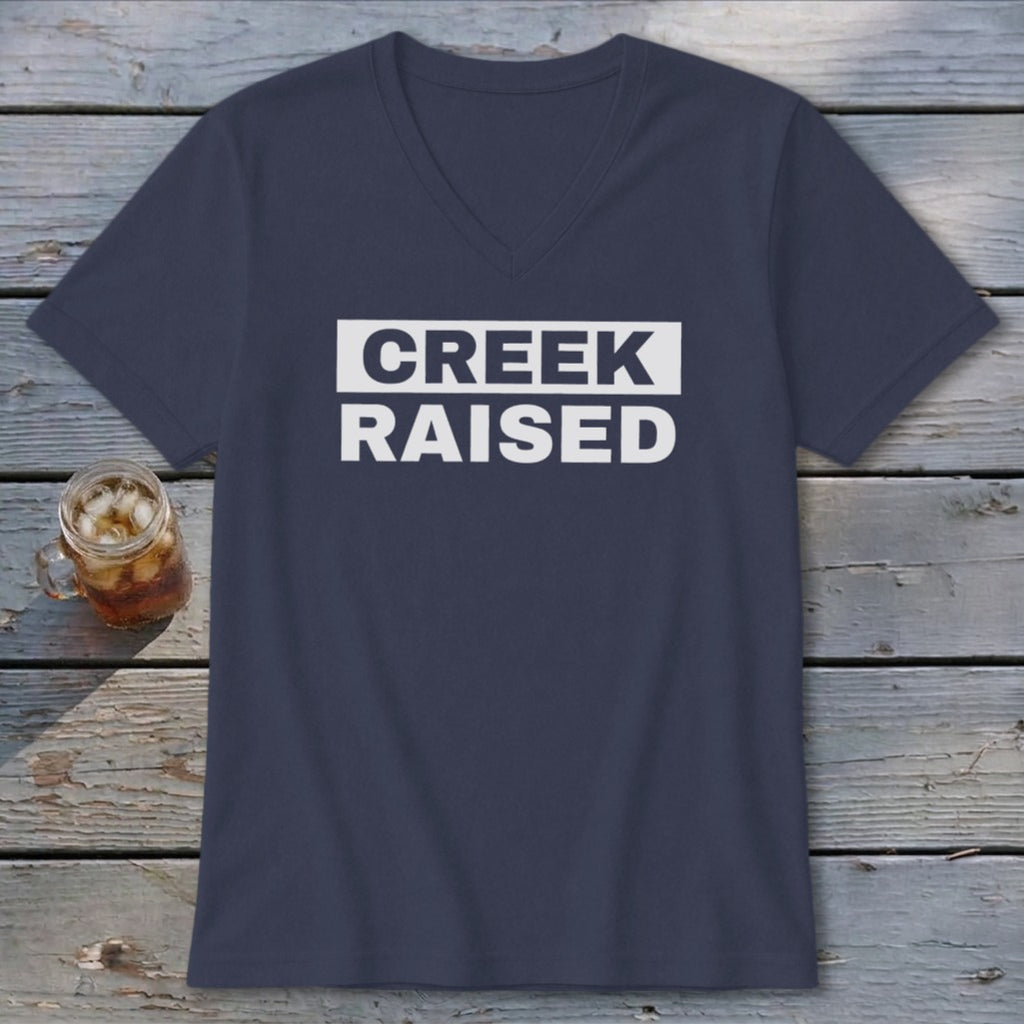 Navy v-neck t-shirt with white text reading "CREEK RAISED".