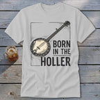 White t-shirt with banjo graphic and text "BORN IN THE HOLLER".