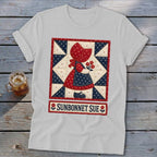 White t-shirt with a Sunbonnet Sue quilt graphic and text.