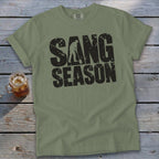 Olive green t-shirt with rolled sleeves featuring distressed black text that reads SANG SEASON.