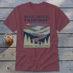 Maroon t-shirt featuring a Blue Ridge Parkway graphic with mountains, winding road, pine trees, and text.