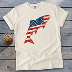 Off-white t-shirt featuring a leaping fish graphic patterned with the American flag, displayed on a wooden surface.