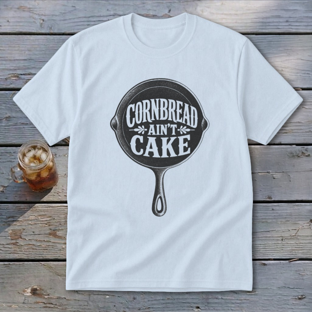 White t-shirt with black text and cast iron skillet graphic that reads "Cornbread Ain't Cake."
