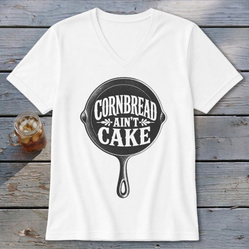 White v-neck t-shirt with cast iron skillet graphic reading "Cornbread Ain't Cake".