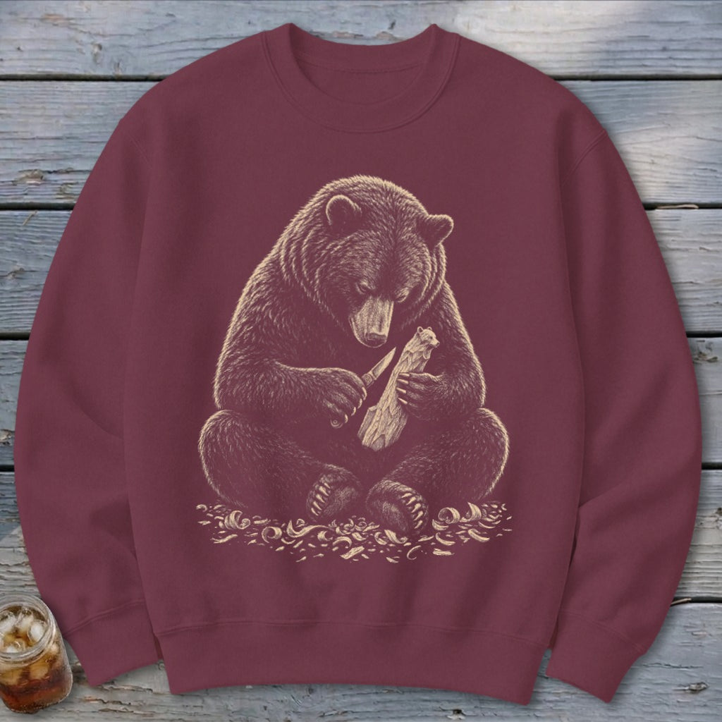 Bear carving a wooden figure with a knife, surrounded by wood shavings.