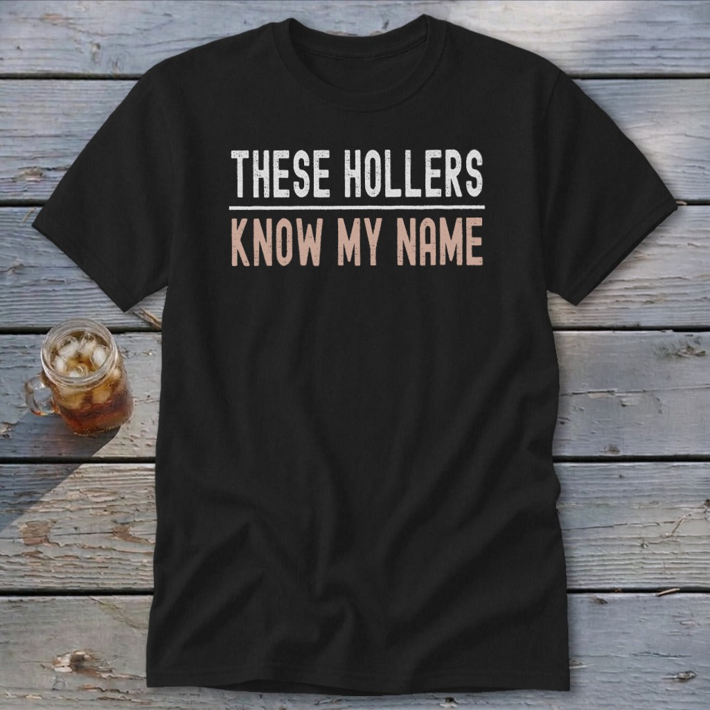 Black t-shirt with "THESE HOLLERS KNOW MY NAME" printed in white and peach.