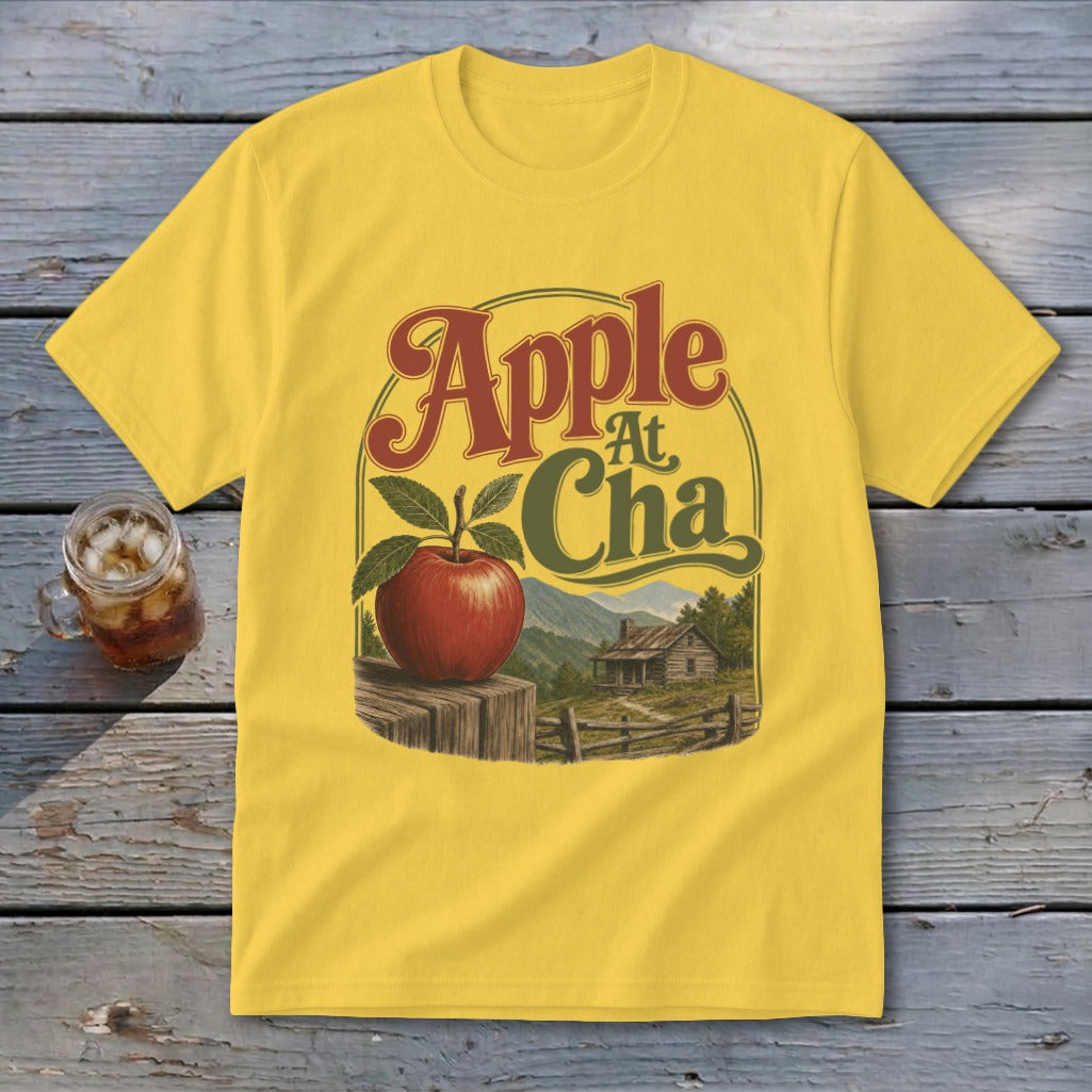 Yellow t-shirt with a vintage graphic featuring an apple, a cabin, and the text Apple At Cha.