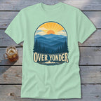 Light green crewneck t-shirt featuring a retro mountain landscape graphic with the text Over Yonder.