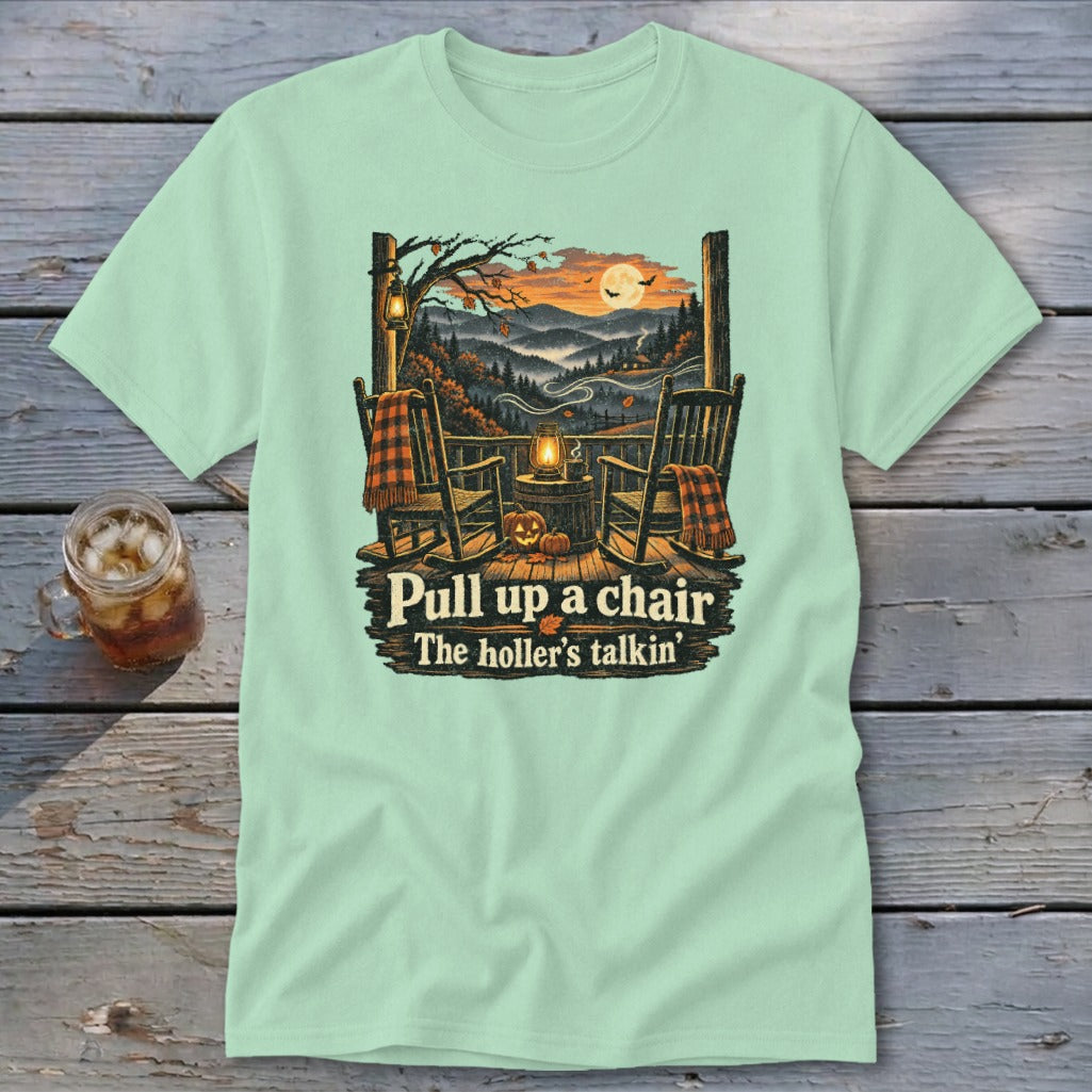Light green t-shirt with porch scene and text "Pull up a chair The holler's talkin'".