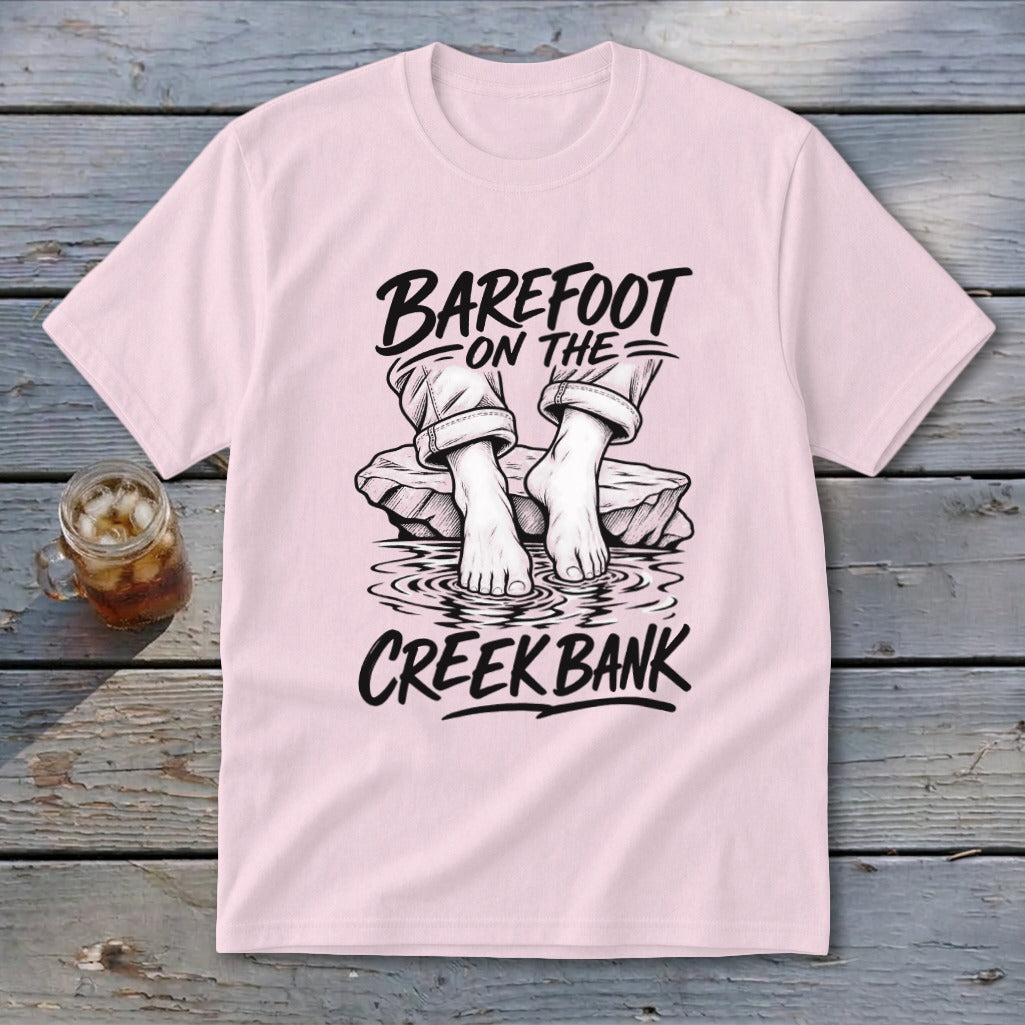 Pink t-shirt with "Barefoot on the Creek Bank" text and illustration.