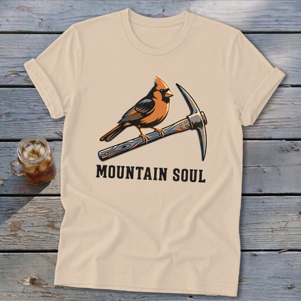 T-shirt graphic featuring a cardinal perched on a pickaxe with text "MOUNTAIN SOUL".