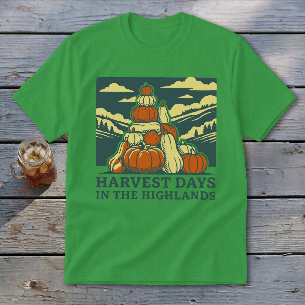 Green t-shirt featuring a graphic of stacked pumpkins with landscape scenery and text reading Harvest Days in the Highlands.