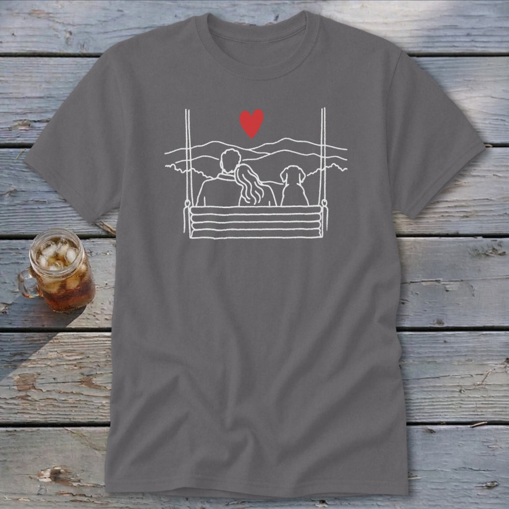 Couple and dog on a swing overlooking mountains, with a red heart above.