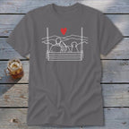 Couple and dog on a swing overlooking mountains, with a red heart above.