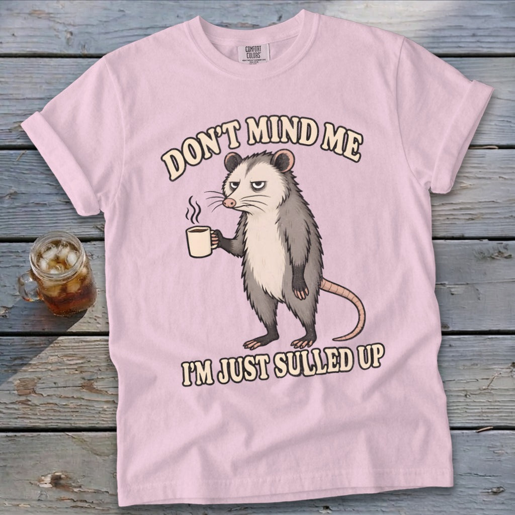 Pink t-shirt with opossum holding coffee and text "Don't mind me I'm just sulled up."