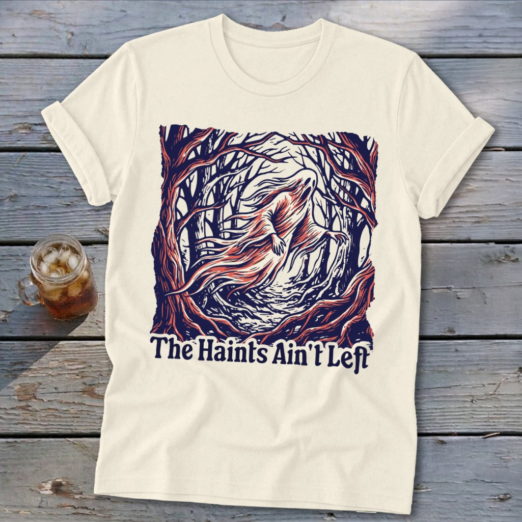 Cream t-shirt with a ghost in a dark forest graphic and text "The Haints Ain't Left".