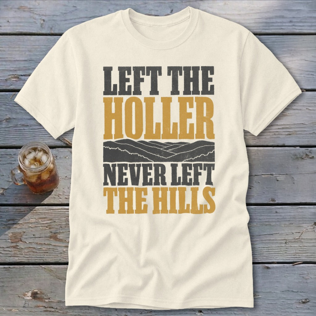 Cream t-shirt with text "LEFT THE HOLLER NEVER LEFT THE HILLS" and mountain graphic.