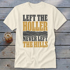 Cream t-shirt with text "LEFT THE HOLLER NEVER LEFT THE HILLS" and mountain graphic.